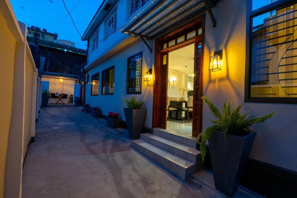 Family-Friendly 2BR: entrance steps lined with potted plants