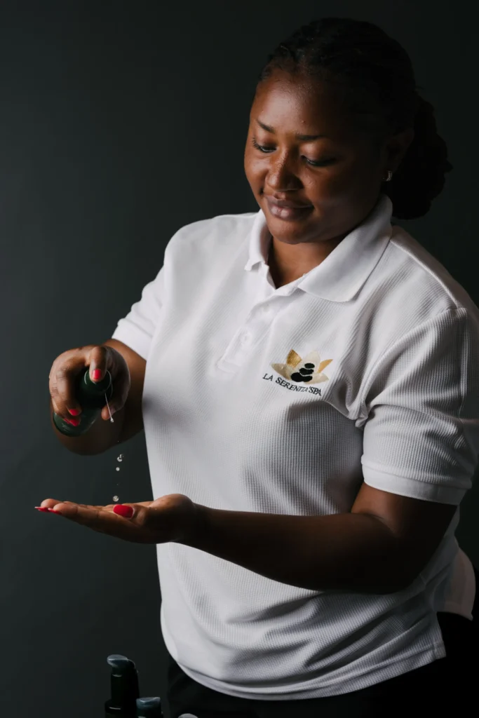 Serenita Spa therapist dispensing massage oil into her palm