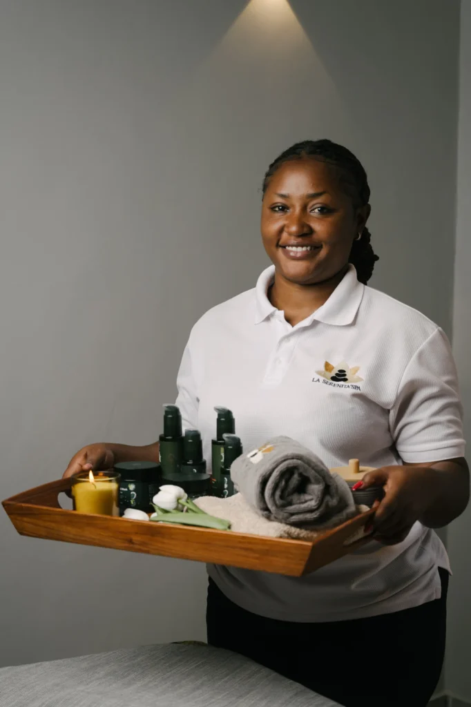 Serenita Spa therapist holding a tray of oils, candles and towels